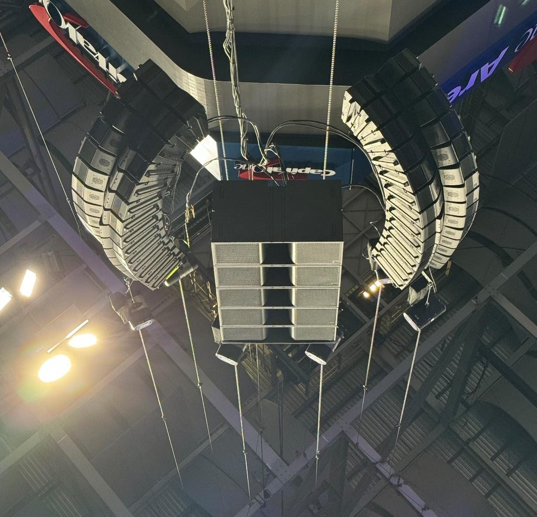 Two reverse-tapered T10 arrays flanking a flown column of T218 subwoofers above the arena floor