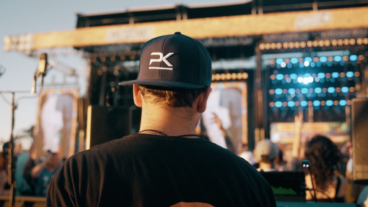 PK Sound crew member in a backwards PK snapback at front of house